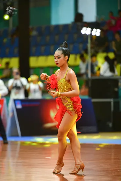 Dancesport competitor: ** Red Latin dress
*   **Color:** Primarily red
*   **Fabric:** Appears to be a 