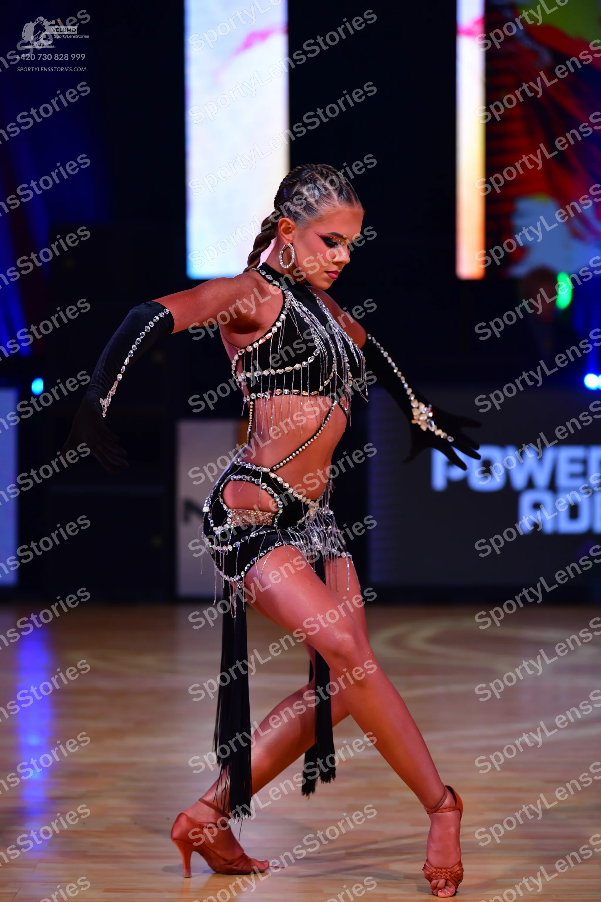 Dancesport competitor: Female dancer: black Latin dance costume with silver rhinestone embellishments a