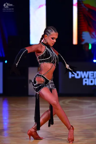 Dancesport competitor: Female dancer: black Latin dance costume with silver rhinestone embellishments a