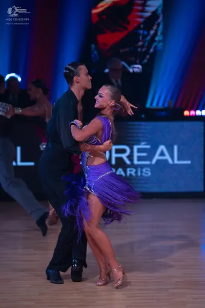Dancesport competitor: Male dancer: black long-sleeved shirt and black trousers