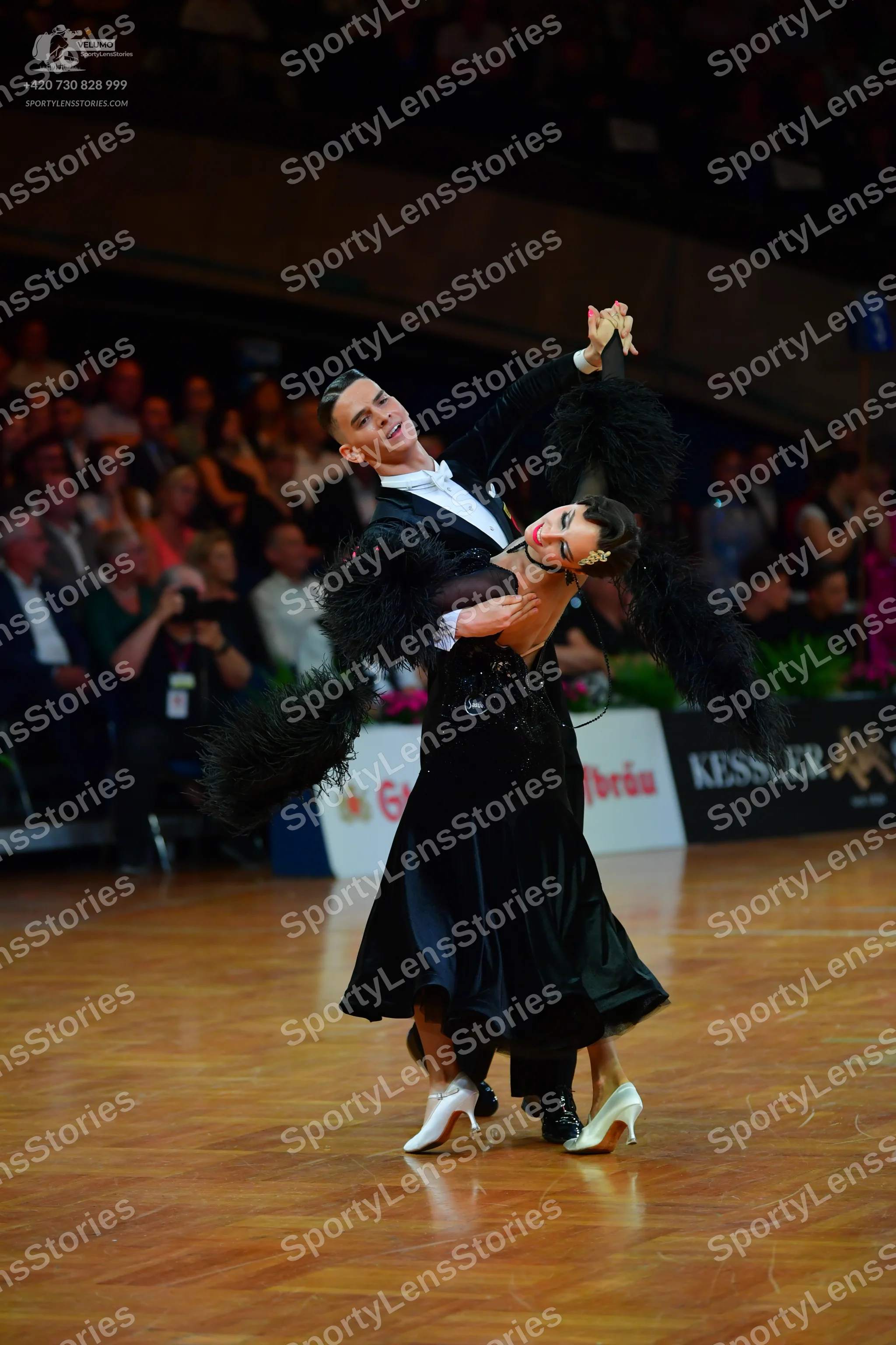 Dancesport competitor: Male dancer: black tuxedo jacket with a white shirt and white bowtie