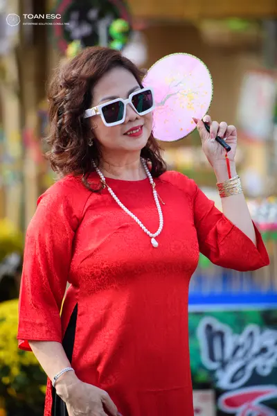 Dancesport competitor: Female dancer: red long-sleeved patterned dress with accessories including white