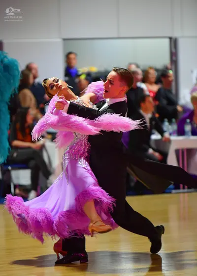Dancesport competitor: Male dancer: black suit with a white shirt