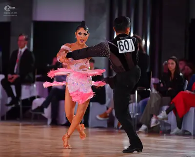 Dancesport competitor #601: Male dancer: black dance shirt with a sequined pattern on the sleeve and black d