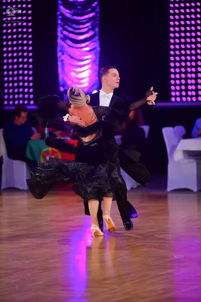 Dancesport competitor: Female dancer: black ballroom dress with a shimmering bodice and a voluminous, f