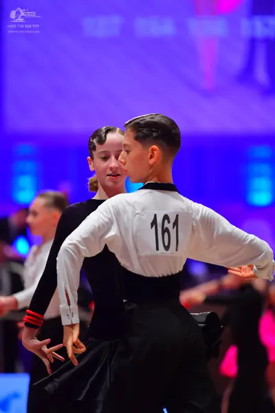Dancesport competitor: Male dancer: white long-sleeved shirt and black trousers