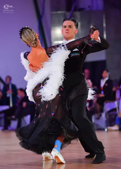 Dancesport competitor: Male dancer: black suit with a white shirt and black bow tie