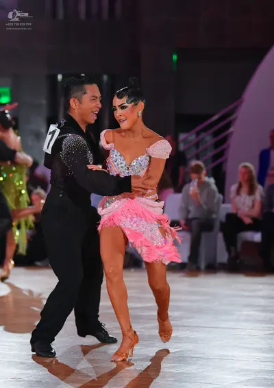 Dancesport competitor: Male dancer: black long-sleeved shirt with silver sequins on the shoulder and bl