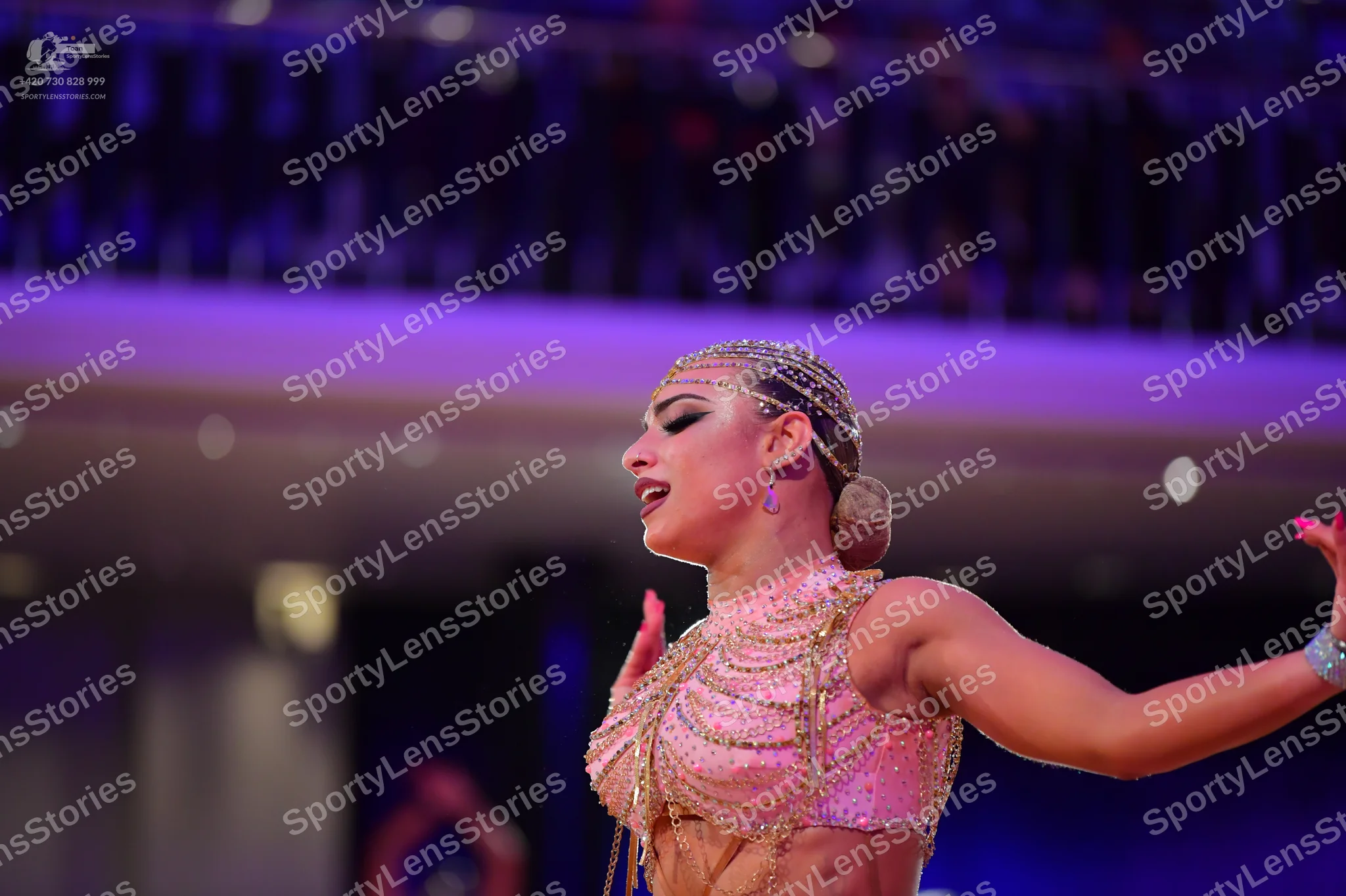 Dancesport competitor: Female dancer: pale pink Latin dance costume, heavily embellished with rhineston