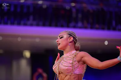 Dancesport competitor: Female dancer: pale pink Latin dance costume, heavily embellished with rhineston