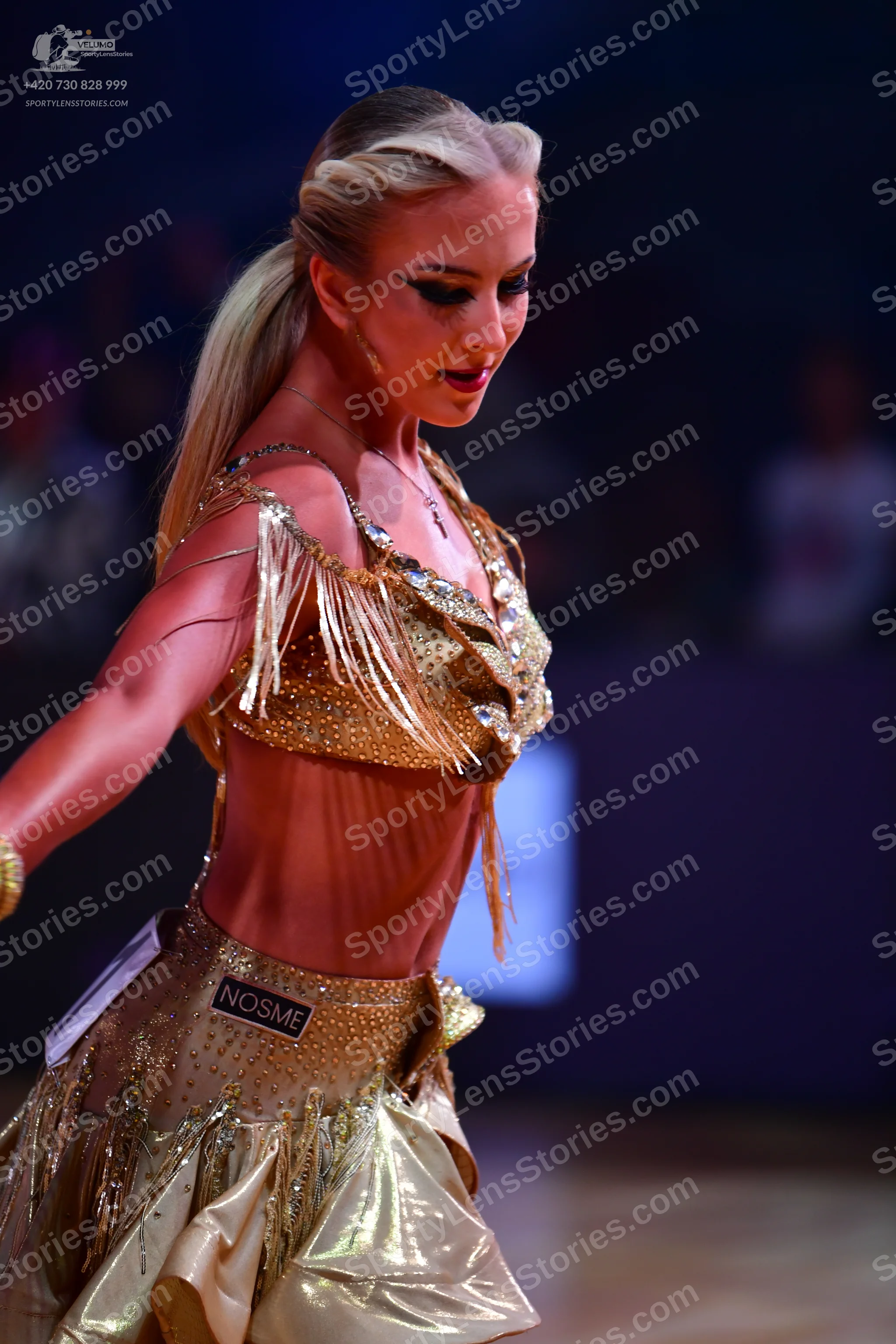 Dancesport competitor: Female dancer: gold latin dance dress with a rhinestone-embellished bodice, long
