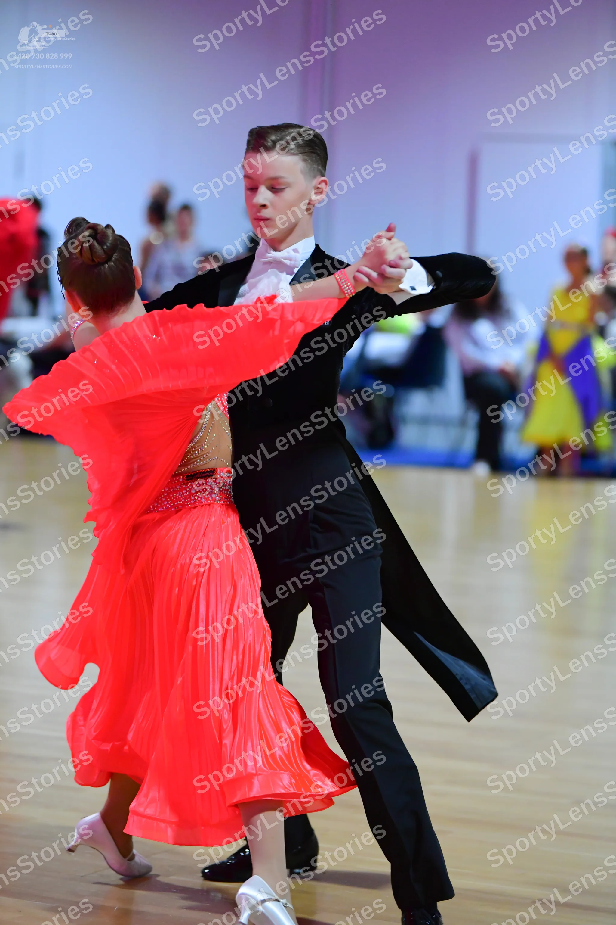 Dancesport competitor: Male dancer: black tailcoat suit with a white shirt, white bowtie, and black tro