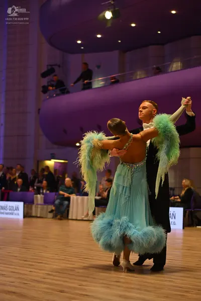 Dancesport competitor: Male dancer: black suit with a white shirt and black bowtie