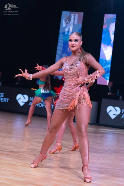 Dancesport competitor: Front female dancer: champagne-colored Latin dance dress with sequins, rhineston