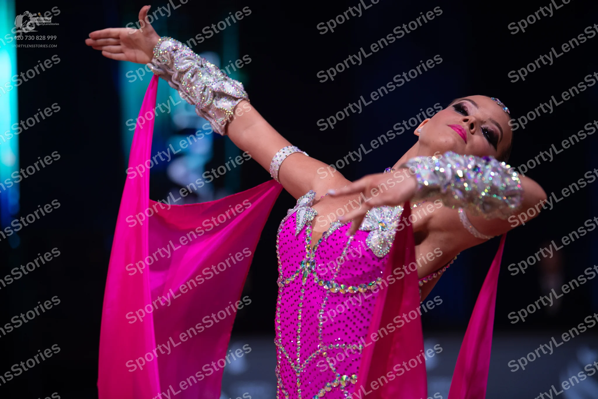 Dancesport competitor: Female dancer: pink latin dance dress decorated with silver sequins and crystals