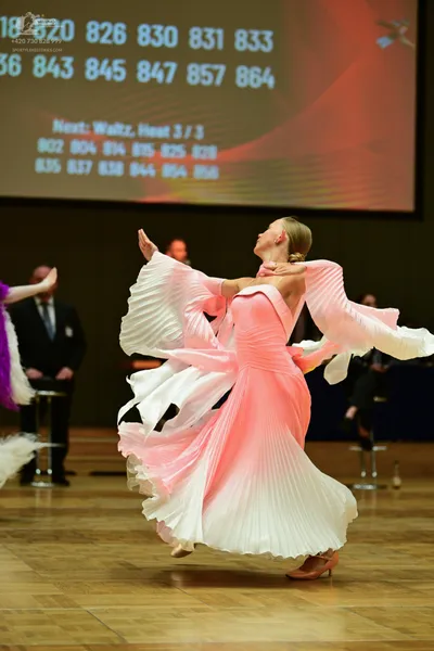 Dancesport competitor #18: Pink pleated dress with a white overlay