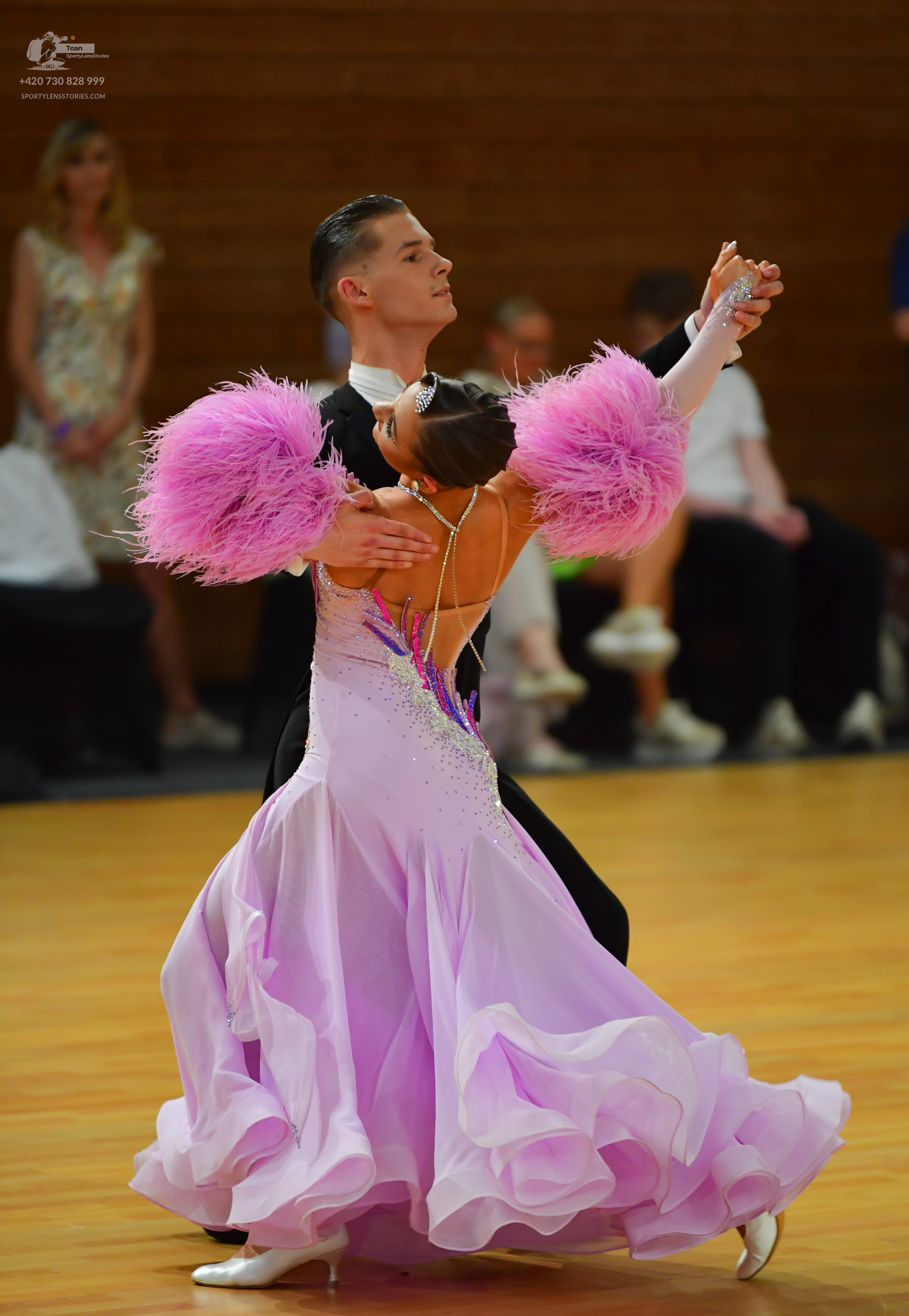 Dancesport competitor: Male:** Black sequin tail suit with a black halter top and a matching black sash