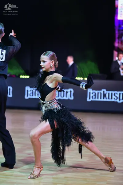 Dancesport competitor: Male dancer: black long-sleeved shirt and black trousers
