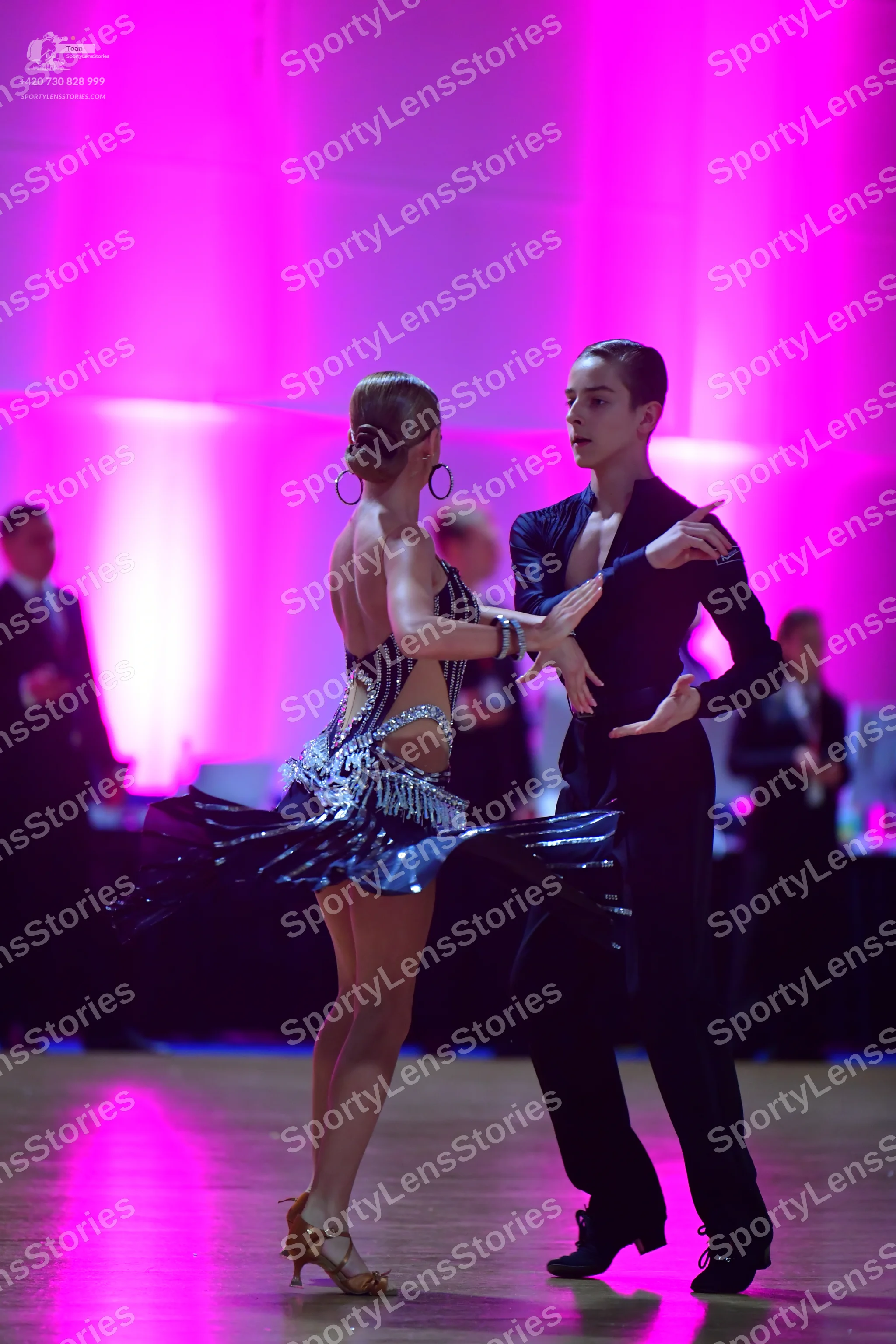 Dancesport competitor: Female dancer: black Latin dress with silver sequin embellishments, backless wit