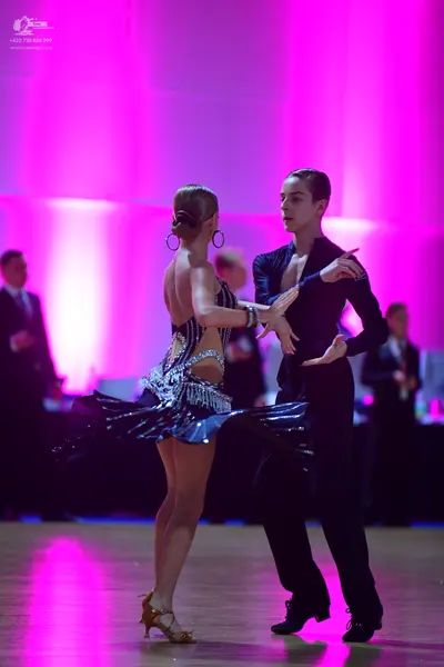 Dancesport competitor: Female dancer: black Latin dress with silver sequin embellishments, backless wit