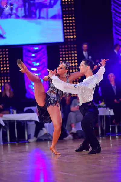 Dancesport competitor: Female dancer: black latin dress with sequins and fringe