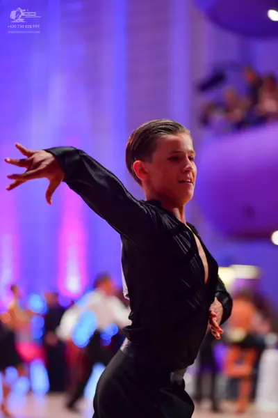 Dancesport competitor: Male dancer: black long-sleeved shirt with a deep V-neck and black trousers
