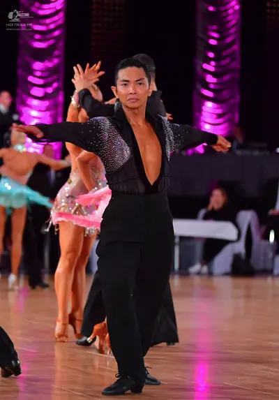 Dancesport competitor: Male dancer: black long-sleeved shirt with a deep V-neck and sequin embellishmen