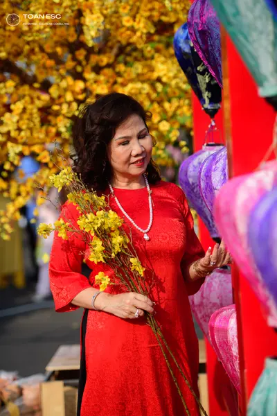 Dancesport competitor: Female dancer: red long-sleeved dress with a textured pattern, accessorized with