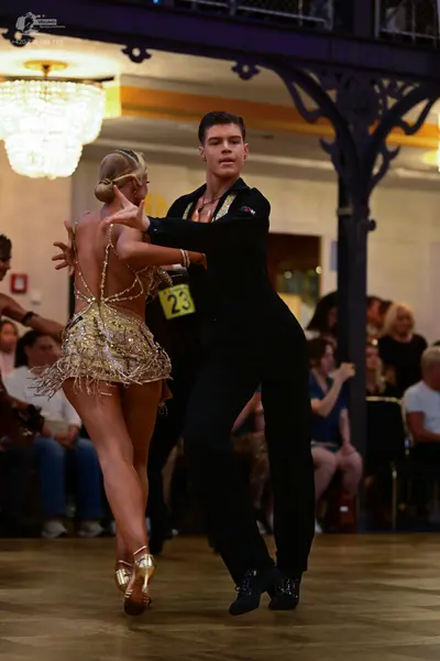 Dancesport competitor #23: Male dancer: black long-sleeved shirt and black trousers