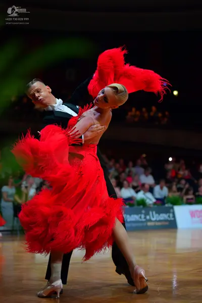 Dancesport competitor: Male dancer: black tuxedo with a white shirt and black bowtie