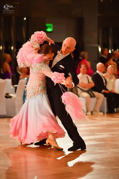 Dancesport competitor: Male dancer: black suit with a white shirt and white bowtie