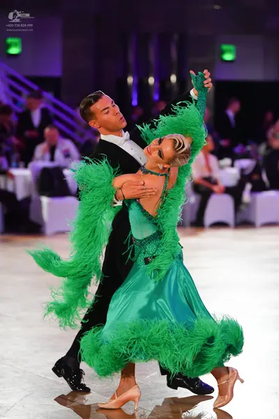 Dancesport competitor: Male dancer: black suit with a white shirt and white bow tie