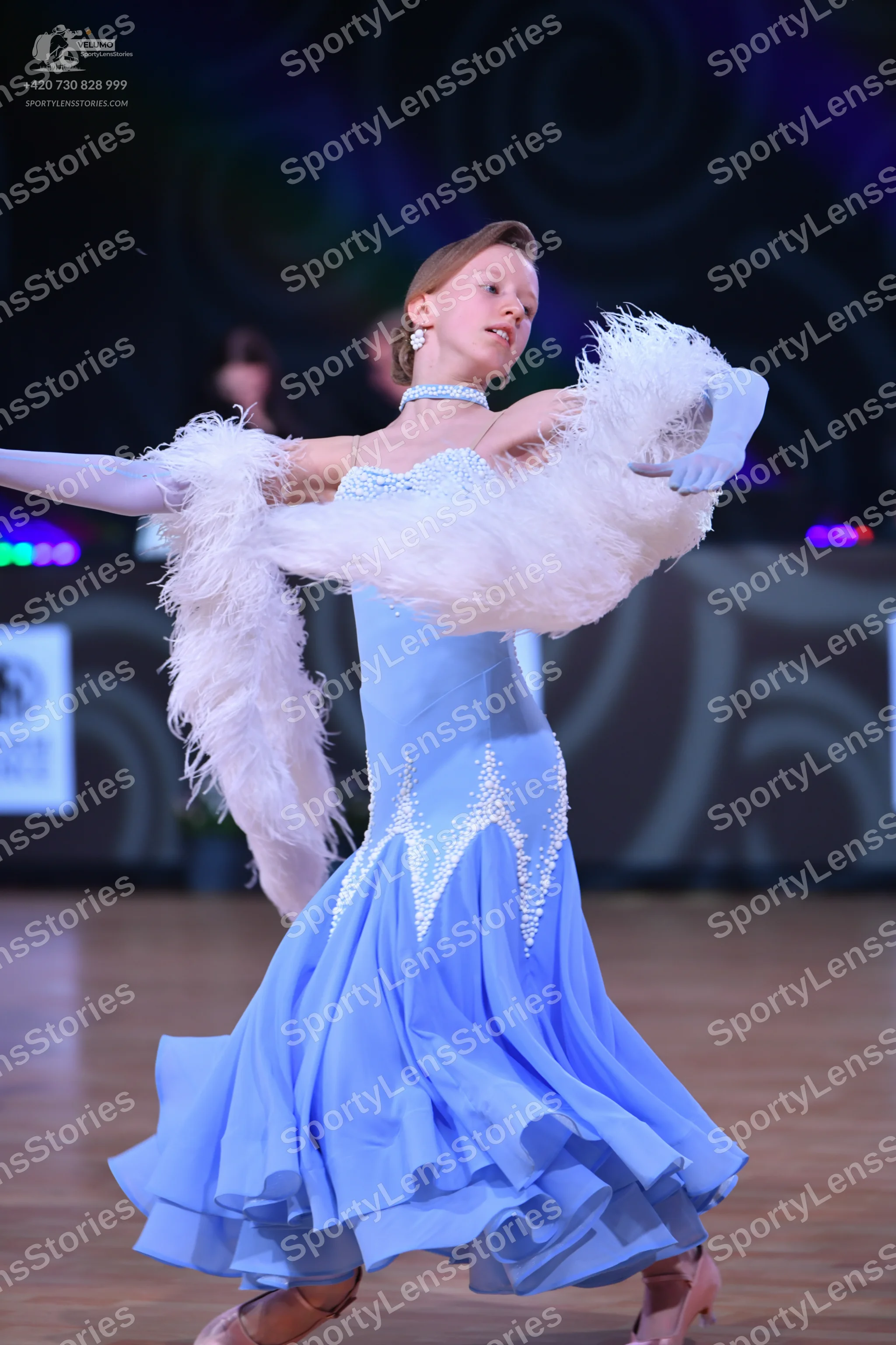 Dancesport competitor: Female dancer: light blue ballroom dress with silver sequin embellishments on th