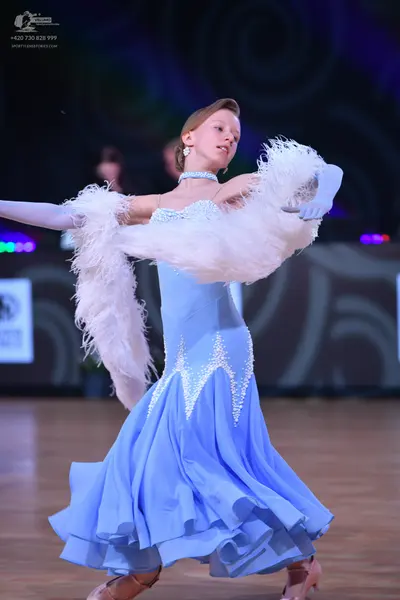 Dancesport competitor: Female dancer: light blue ballroom dress with silver sequin embellishments on th