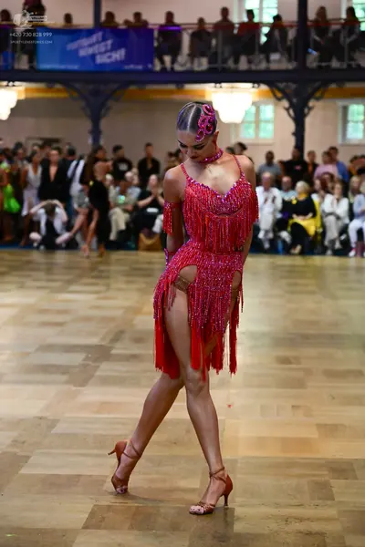 Dancesport competitor: Female dancer: red latin dress with fringe