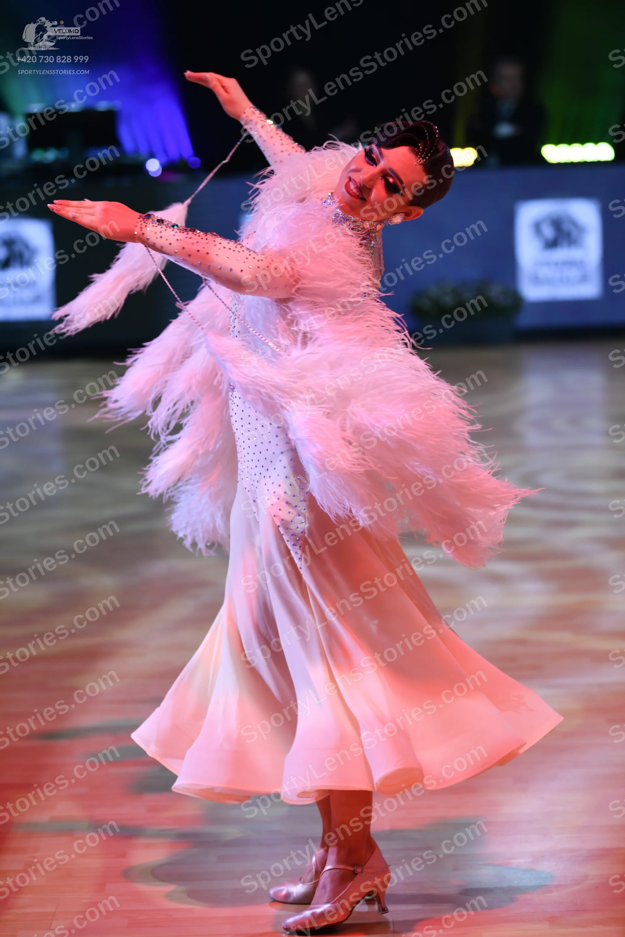 Dancesport competitor: Female dancer: light pink/peach ballgown with a sequin-embellished bodice and lo