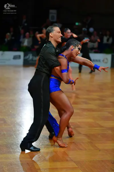 Dancesport competitor: Male dancer: black long-sleeved shirt and black trousers