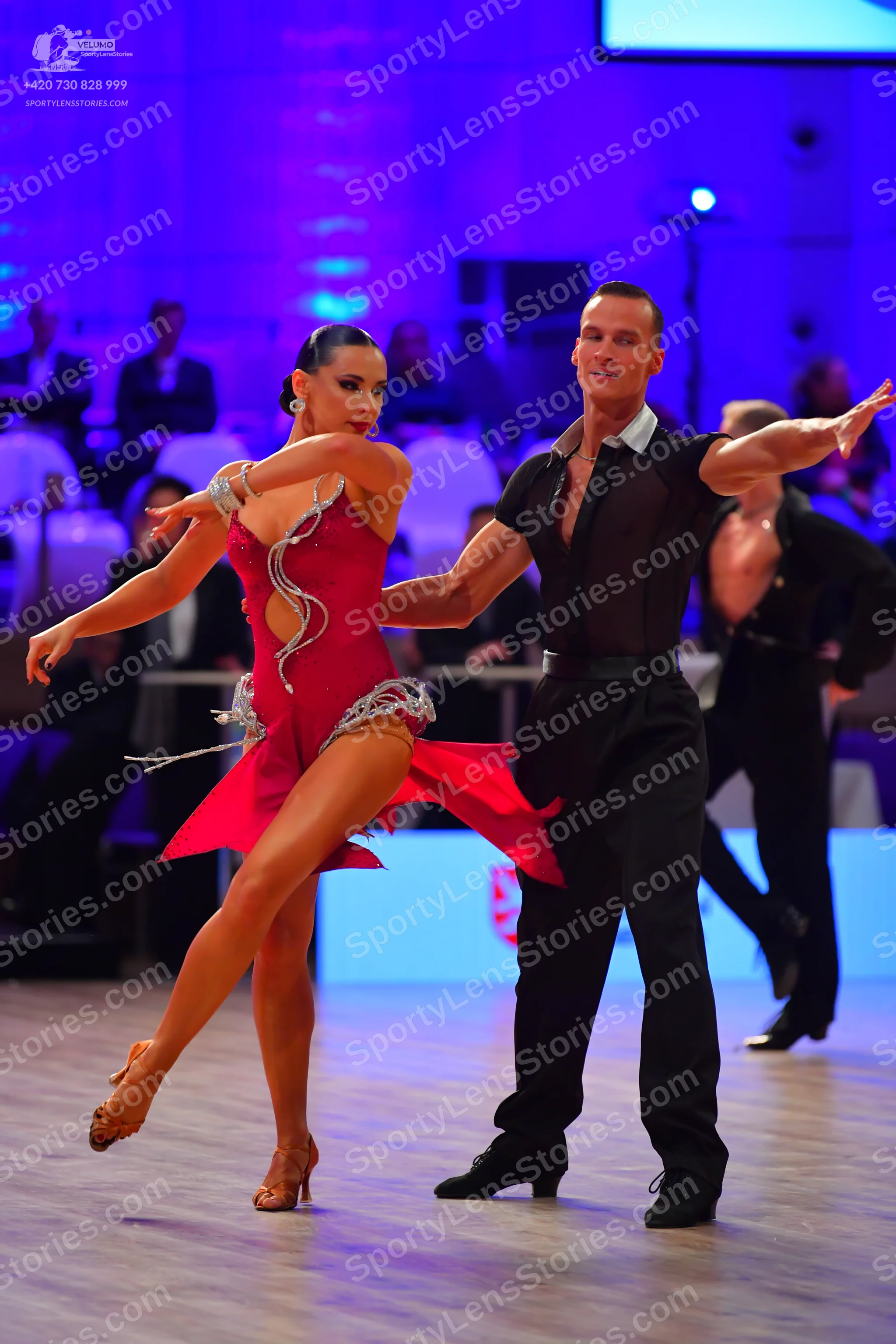 Dancesport competitor: Female dancer: red latin dress with silver rhinestone embellishments