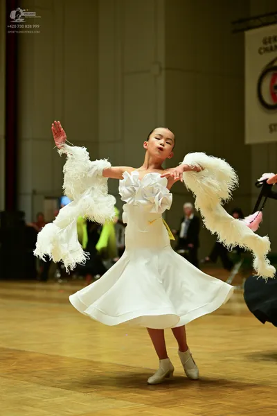 Dancesport competitor: ** White ballgown style dress