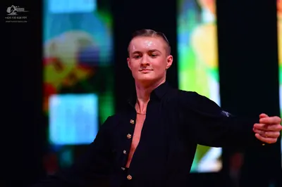 Dancesport competitor: Male dancer: black shirt, partially unbuttoned