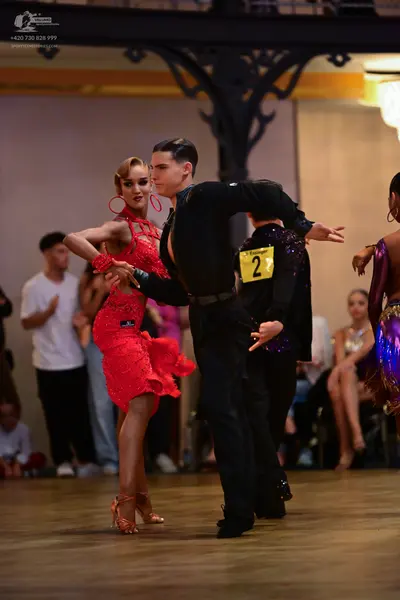 Dancesport competitor: Male dancer: black long-sleeved shirt and black trousers