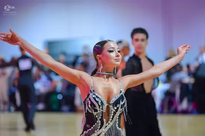 Dancesport competitor: Female dancer: black latin dress with silver sequins/rhinestones and thin straps