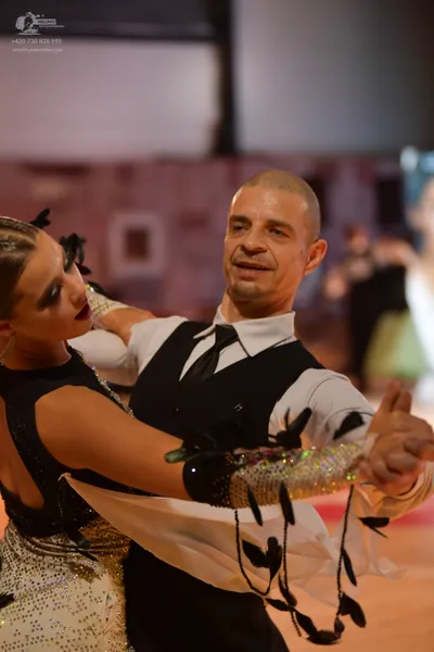 Dancesport competitor: Male dancer: white shirt, black necktie, and black waistcoat