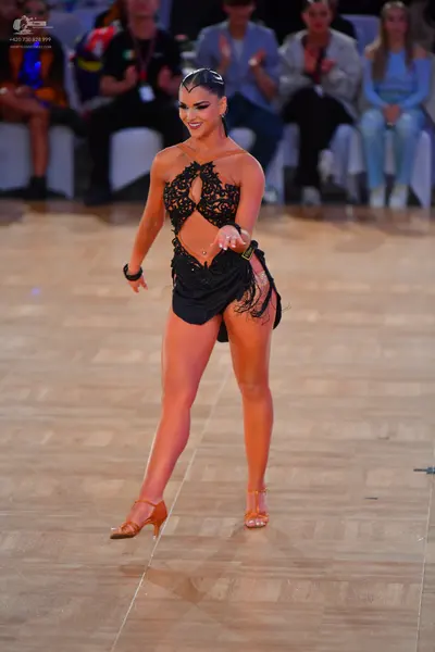 Dancesport competitor: Female dancer: black latin dress with lace cutout bodice and fringe skirt