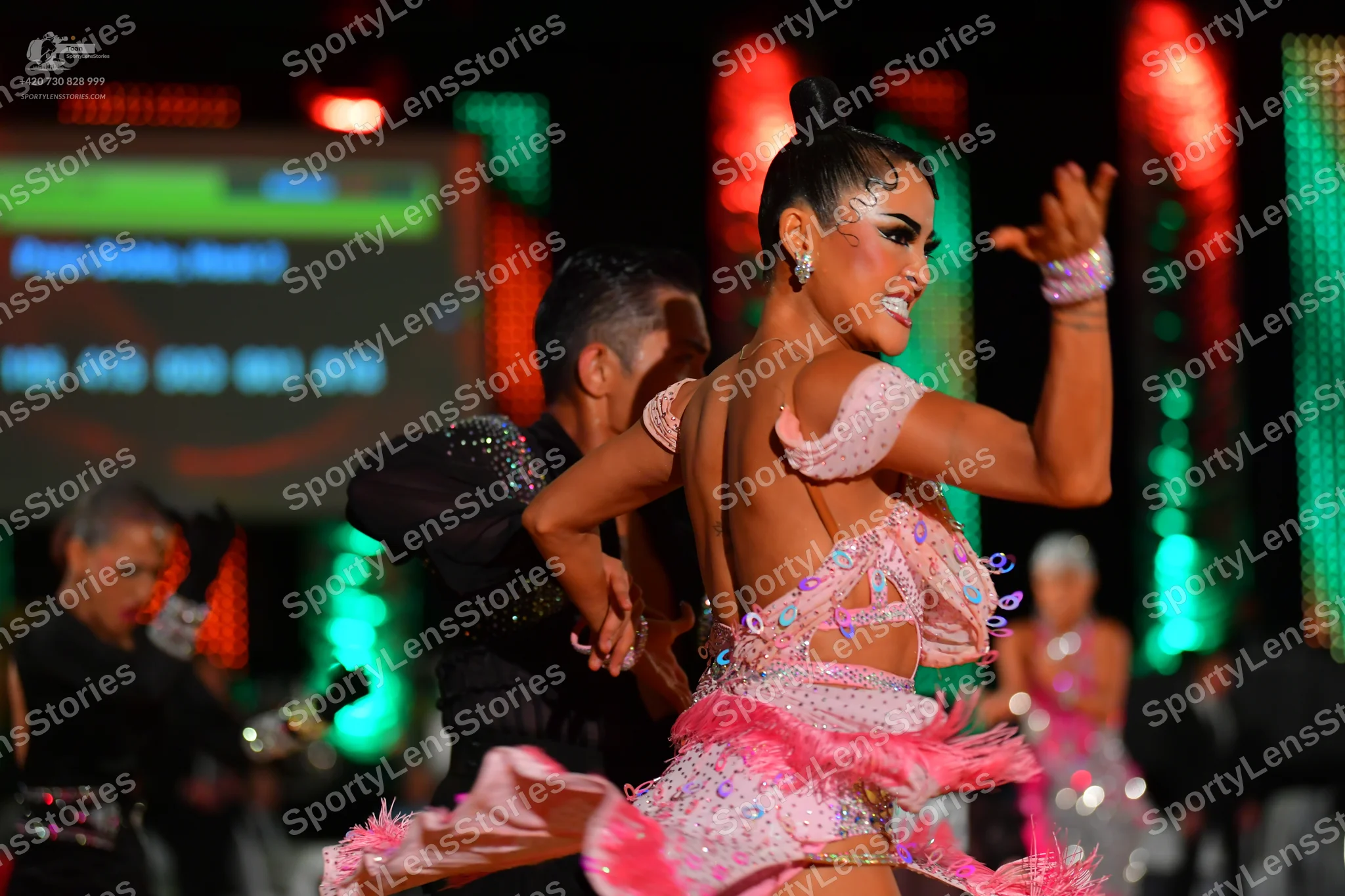 Dancesport competitor: Main female dancer: light pink Latin dance dress with heavy rhinestone and sequi