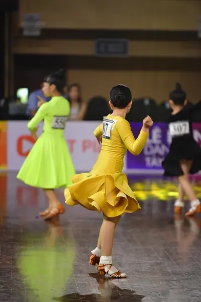 Dancesport competitor #36, #77: Lime green dancer: neon green latin dress with a short skirt