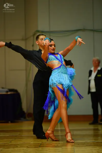 Dancesport competitor: Male dancer: black long-sleeved shirt and black trousers