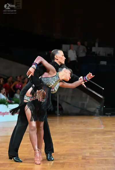 Dancesport competitor: Male dancer: black long-sleeved shirt and black trousers