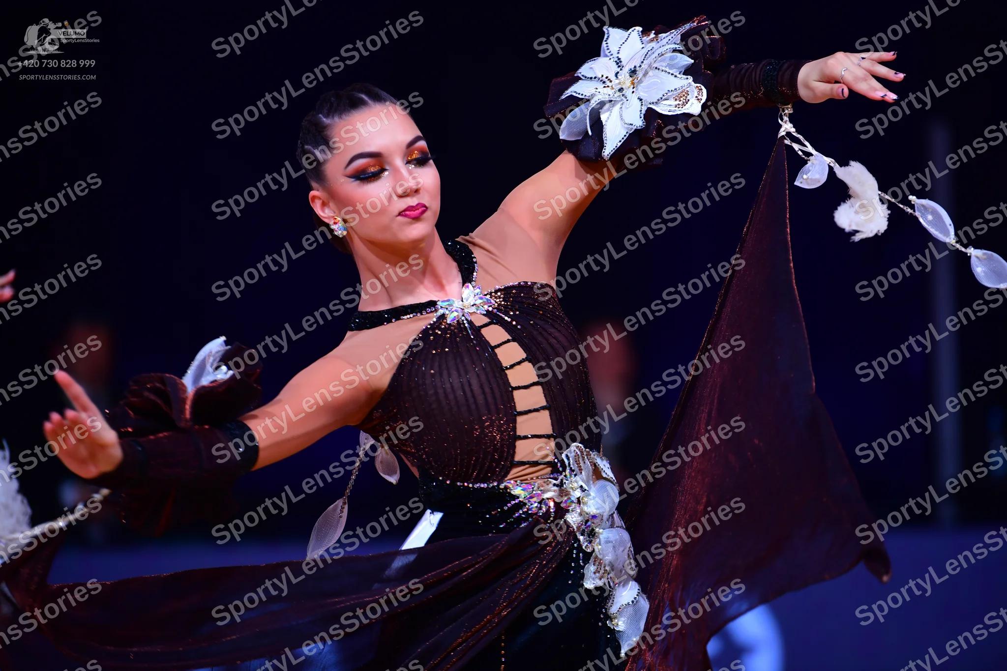 Dancesport competitor: Female dancer: dark brown Latin dance dress featuring sheer mesh panels, a lace-