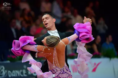 Dancesport competitor: Male dancer: black suit with a white shirt and white bow tie